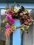 Join Flower Farmer and Florist Georgie Newbery as she shows you how to make a fabulous autumn wreath out of entirely foraged materials from her gardens at Common Farm in Somerset. Using twigs and berries, seed heads, foliage, and dried flowers, she’ll show you how to twist together a rustic circle of twigs, and how to create a garland of goodies with which to dress it.
