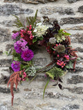 Join Flower Farmer and Florist Georgie Newbery as she shows you how to make a fabulous autumn wreath out of entirely foraged materials from her gardens at Common Farm in Somerset. Using twigs and berries, seed heads, foliage, and dried flowers, she’ll show you how to twist together a rustic circle of twigs, and how to create a garland of goodies with which to dress it.